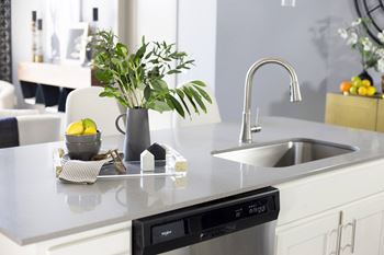 a kitchen with an island, sink, and a dishwasher  at Avant & Avant II, Carmel, Indiana